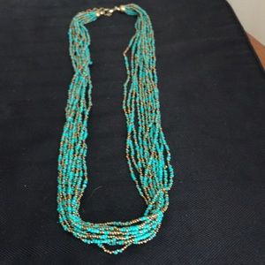 Turquoise and gold beaded necklace.